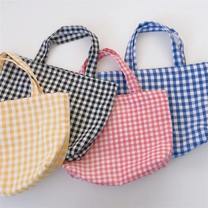 Detailed set of four gingham pattern lunch bags in yellow, black, pink, and blue