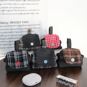 Mini backpack style tweed earphone cases in various plaid patterns for storage