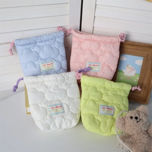Close-up of quilted cotton drawstring bags with cloud pattern in pastel colors
