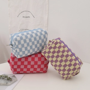 Knitted checkerboard makeup bag in colorful plaid patterns with metal zipper closure