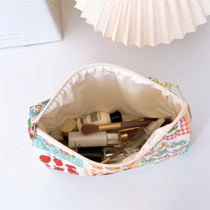 Detail of floral quilted cotton makeup bag showing spacious interior and soft lining