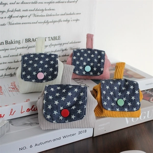 Corduroy mini coin purses with star pattern lids and colorful buttons shown in four colors