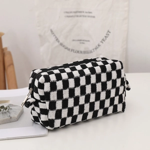 Black and white checkered knit pouch with zipper closure for makeup storage
