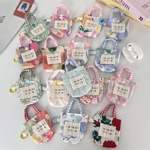 Mini pochettes à motifs floraux pour écouteurs avec boutons-pression et poignées tissées