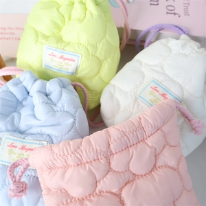 Quilted drawstring storage pouch in pastel colors with heart pattern embroidery