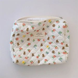 Top view of floral quilted cotton makeup bag with bear prints and zipper closure