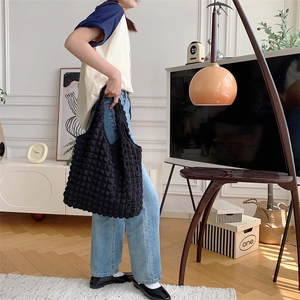 Detail of black cloud bubble texture tote bag showing spacious design and soft puff fabric