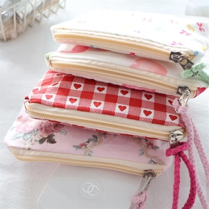 Mini floral and heart pattern storage pouches with zipper closure and colorful drawstrings