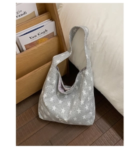Detail of grey striped hobo bag with white star prints and casual adjustable strap