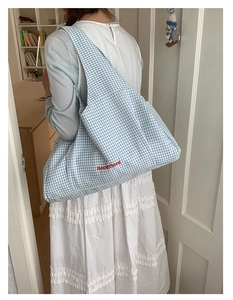 Detail of blue gingham tote bag with red GoodThing embroidery and wide shoulder strap