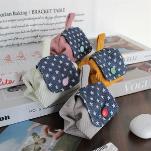 Detailed view of colorful corduroy mini storage bags with star denim flap and button