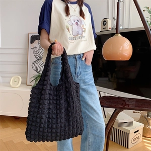 Detail of black popcorn textured fabric on a large capacity minimalist tote bag