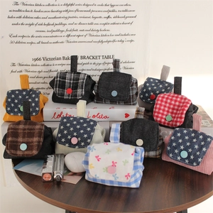 Detailed view of mini fabric storage pouches with colorful buttons and vintage patterns