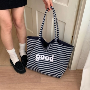 Striped canvas tote bag with good letter print for women shown in lifestyle setting