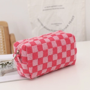 Pink checkered knit pouch with a silver zipper for makeup storage and daily organization