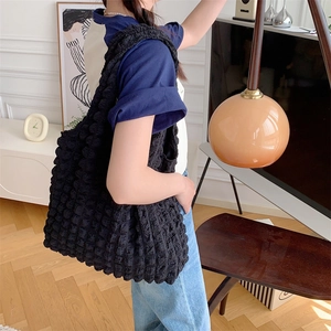 Detail of black cloud bubble texture fabric on a versatile large shoulder tote bag