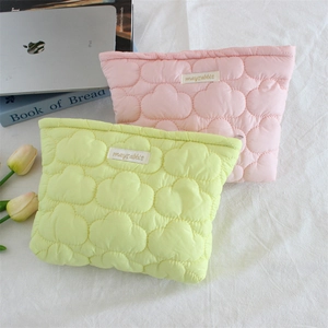 Detailed cloud-quilted puffy cosmetic bags in pink and green with woven mayrabbit label