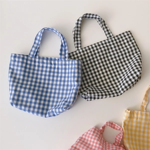 Flat lay of Gingham pattern lunch bags in blue, black, red and yellow cotton canvas