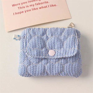 Detailed view of quilted heart pattern on blue striped mini coin purse with snap button