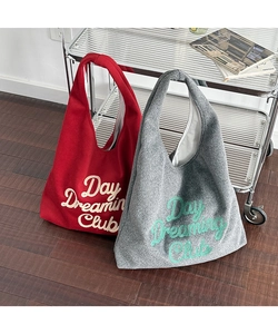 Close-up of wool tote bag featuring Day Dreaming Club embroidery and soft felt texture