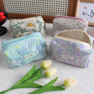 Embossed jacquard pencil cases and cosmetic bags in four colorful floral patterns
