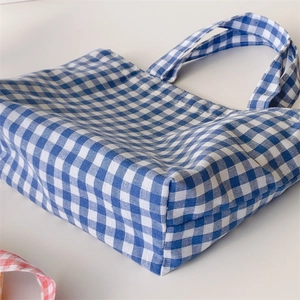 Close-up of blue and white checkered bento bag with durable cotton handles