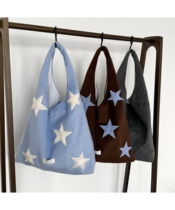 Detailed comparison of three woolen tote bags featuring embroidered star patterns and woven labels