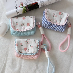 Quilted floral camera case and earphone pouch set with pom-pom trim and woven lanyard