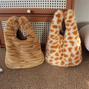 Plush leopard and tiger print faux fur handbags with a soft U-shaped handle design