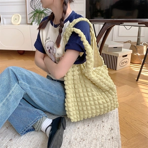 Detail of soft yellow popcorn texture fabric on this casual shoulder tote bag for women