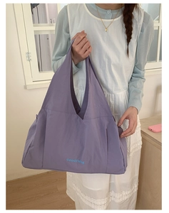 Detailed view of the large purple plaid tote bag showing the GoodThing logo on nylon fabric