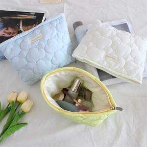 Quilted cloud cosmetic bag in multiple colors with spacious interior and zipper closure