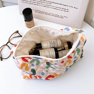 Detailed top view of quilted floral cosmetic bag interior showing spacious storage capacity