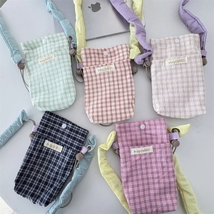 Detailed view of checkered mini crossbody bags with scrunchie handles in five colors