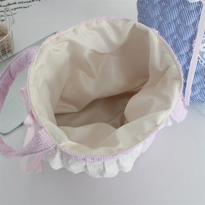 Detail of the pink checkered bag showing creamy silk lining and white lace trim