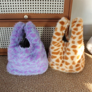 Detail of plush faux fur tote bags with leopard and giraffe prints and checkered lining