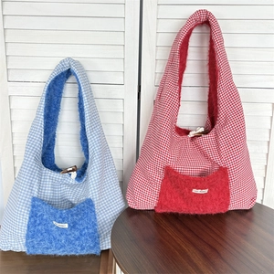 Detail of red and blue checkered tote bags with plush pockets and May Rabbit label