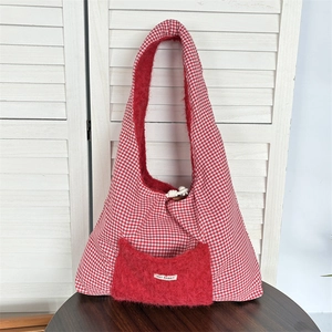 Detail of red and white checkered tote bag with a plush pocket and May Rabbit label