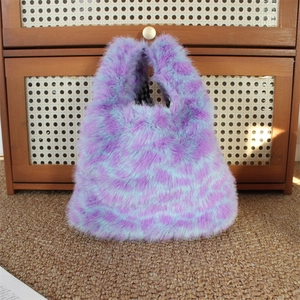 Detailed view of plush purple leopard print faux fur handbag with black checkered lining