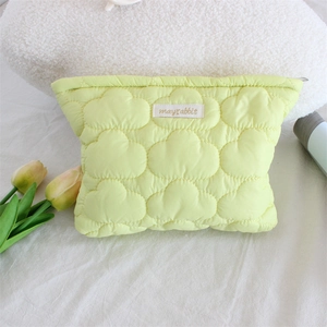 Detail of light green quilted cloud bag with mayrabbit label and zipper closure