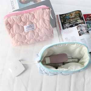 Close-up of quilted heart pattern and spacious interior on cloud-style makeup bags