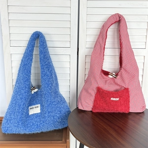 Detail of reversible tote bags with wood toggle closure and soft plush fabric texture