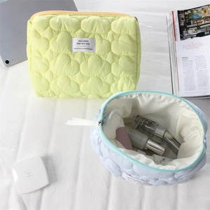 Detailed view of quilted cosmetic bags with soft puffy texture and large capacity storage
