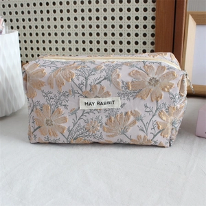 Macro detail of lavender embossed jacquard pencil case with daisy floral patterns