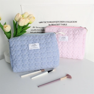 Detailed view of quilted cotton cosmetic bags with blue stripes and pink heart patterns