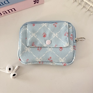 Detail of corduroy coin purse with floral print, front pocket and zipper closure