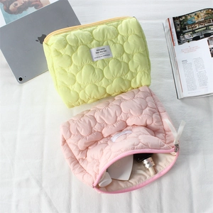 Quilted cloud makeup bags in neon green and pink colors for travel storage