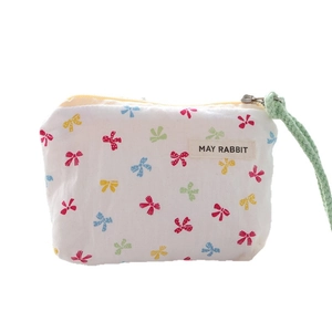 Mini canvas pouch with colorful bow prints and convenient side carrying loop for earbuds