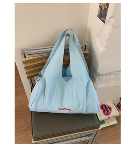 Detail of light blue minimalist tote bag with red GoodThing letter print on fabric