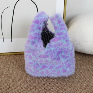 Detail view of plush faux fur tote with leopard print and black checkered lining